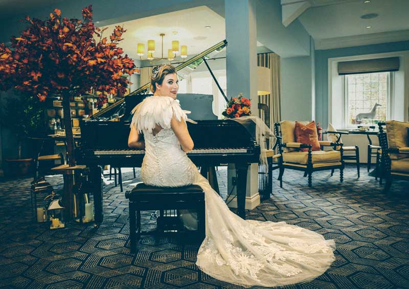 Bride playing the grand piano in the music rooms at Hogarths Hotel in Solihull